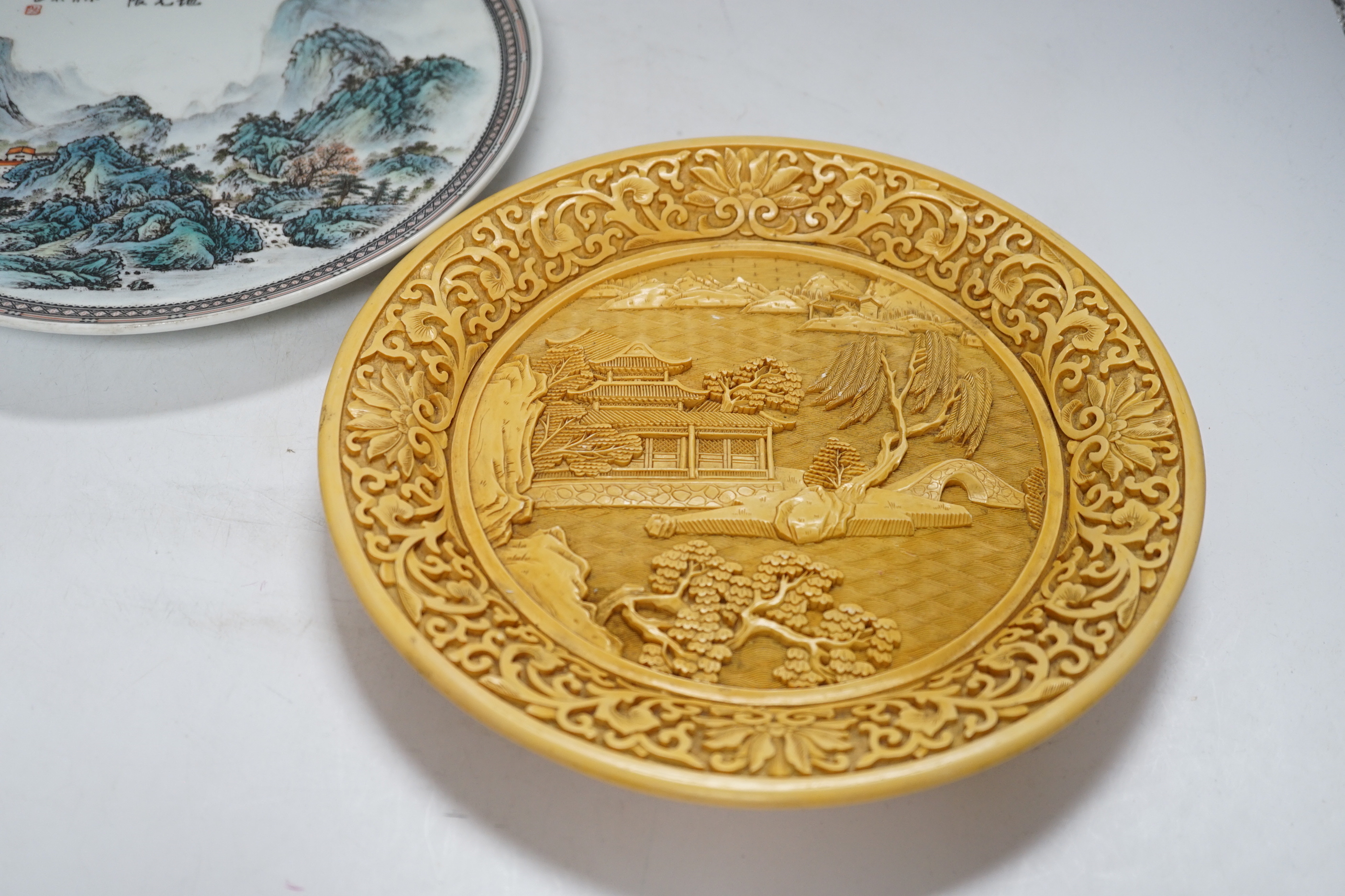 Two Chinese plates, resin and porcelain, largest 26cm diameter